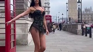 Ivana Knoll dances around a lamp post in London