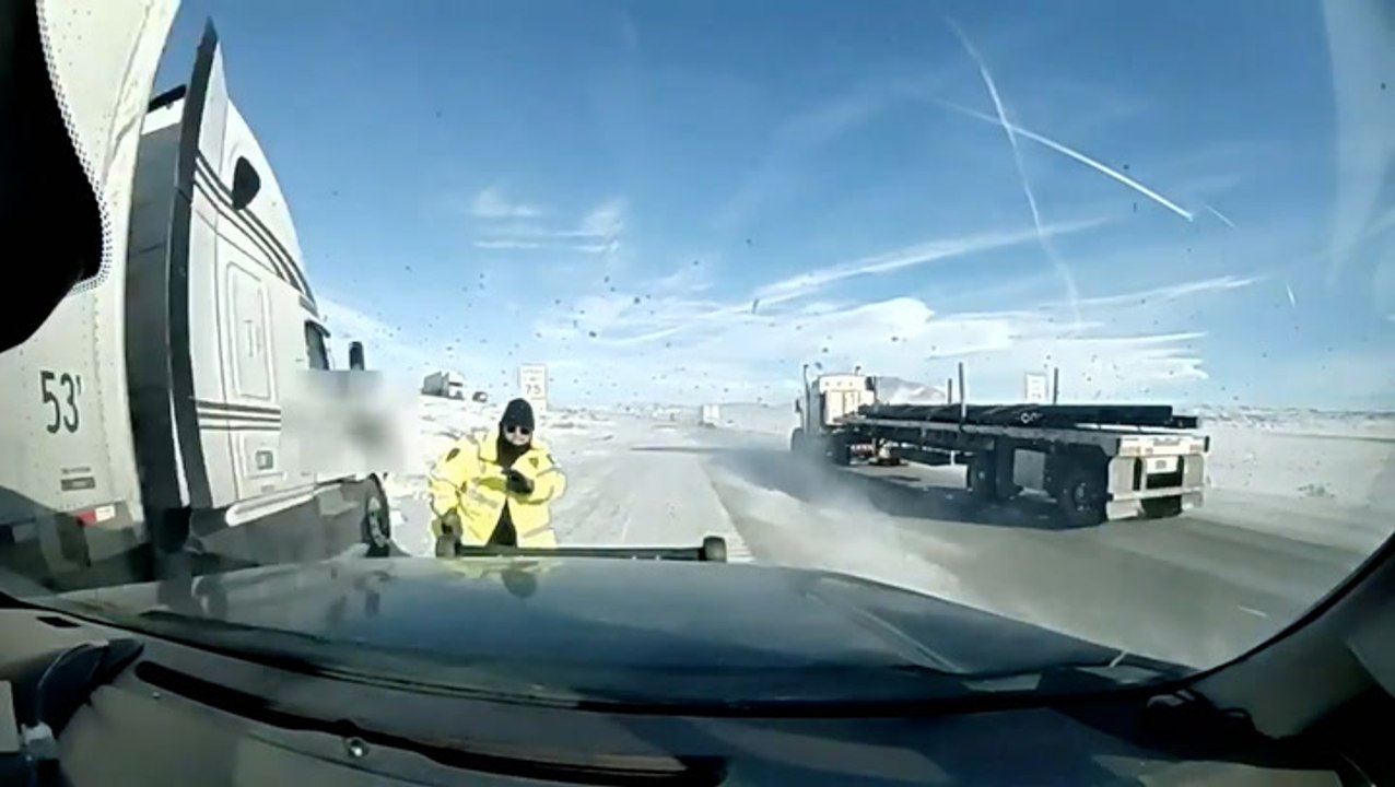 Truck nearly crashes into highway patrol trooper on snowy interstate