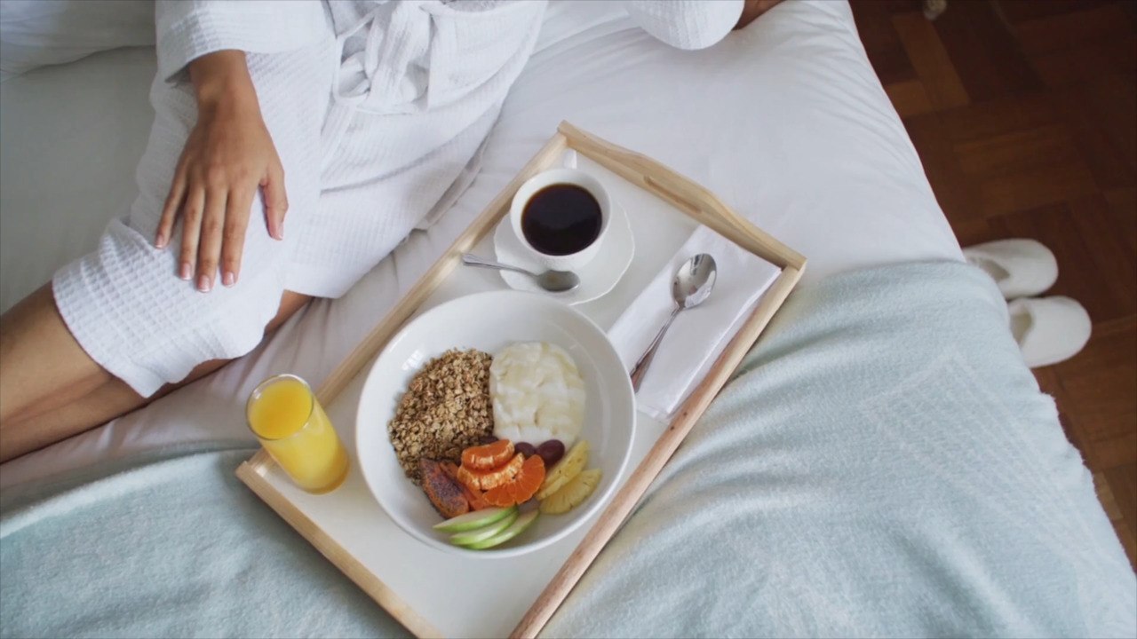 Is Snacking in Bed Actually That Bad?