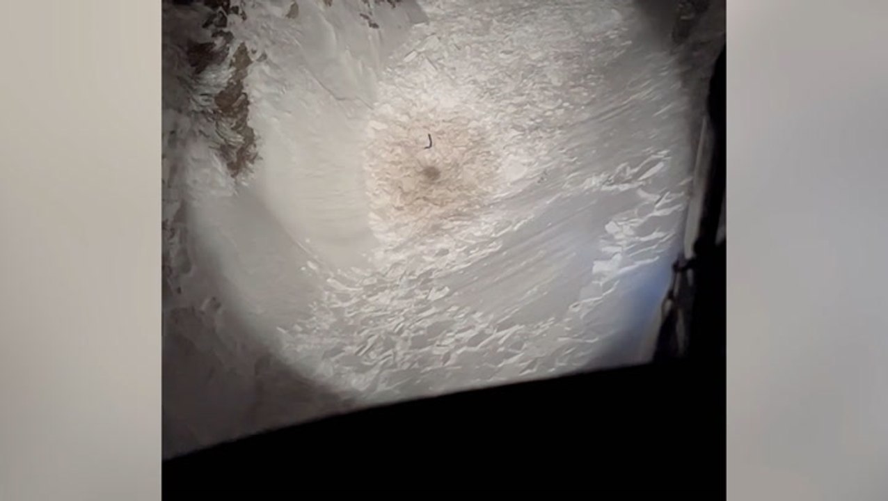 Moment missing hiker trapped under avalanche waves down rescue helicopter