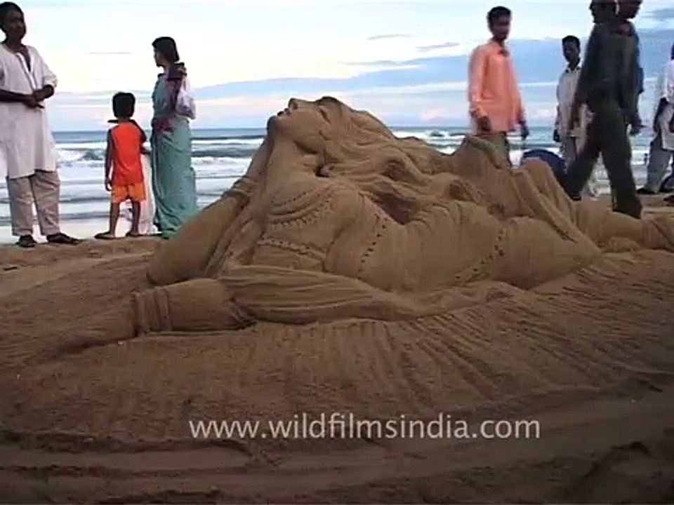 Sand sculpture _ creating a mythical creature using one's hand, Puri Beach