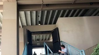 Skateboarder attempts to board slide handrail then falls and hits top of head (Angle 2/2)