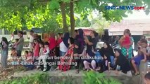 Meriahkan HUT ke-77 RI, Emak-emak di Tebing Tinggi Kibarkan Merah Putih di Sungai Bahilang