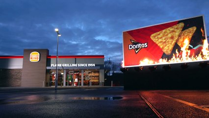 Shocking moment a 200 square foot high street billboard went up in flames