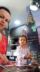 Little Girl Helping Mom Bake Mixed Cake Adds an Extra Ingredient