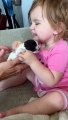 Little Girl Reacts to Holding Tiny Puppy