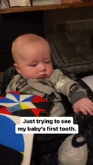 Baby adorably blocks mommy from showing his teeth