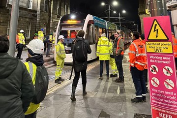Edinburgh busker sings as tram travels down Leith Walk in historic moment