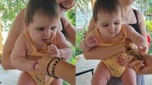 Baby girl tries to eat a chicken ALIVE while visiting grandparents' village