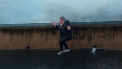 Woman learns that her feet aren't quick enough to escape the might of raging waves