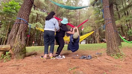 Girls learn that getting off a hammock can be as complicated as getting in one