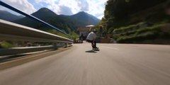 Person Skates on Longboard While Going Downhill on Road