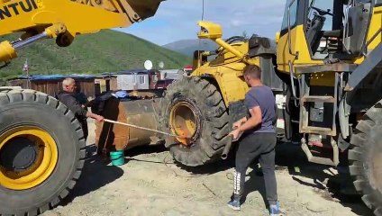 Guys Remove Bulldozer Tire