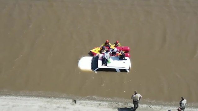 Three people and dog rescued from flooded car after driving around road closure signs