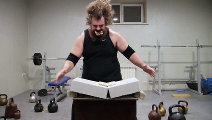Man Breaking A Concrete Block With His Head