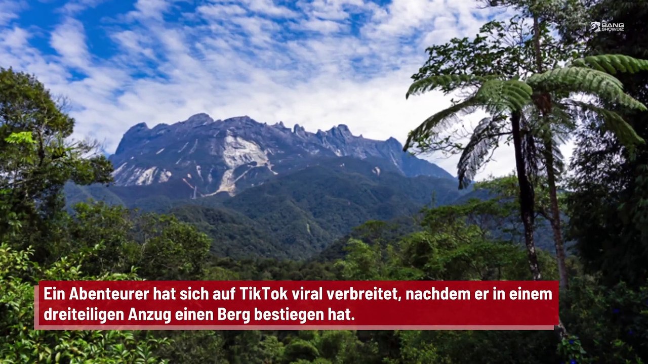 Schneider besteigt Berg in dreiteiligem Anzug