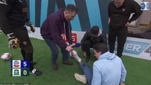 Soccer AM producer 'Curly' is left in agony after former Liverpool star Jose Enrique trips over him and lands on his shin during the show's Carpark Volley challenge... but the crew member insists 'all is
