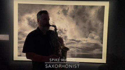 Spike Mason plays in front of Murray Fredericks' Witness exhibition.