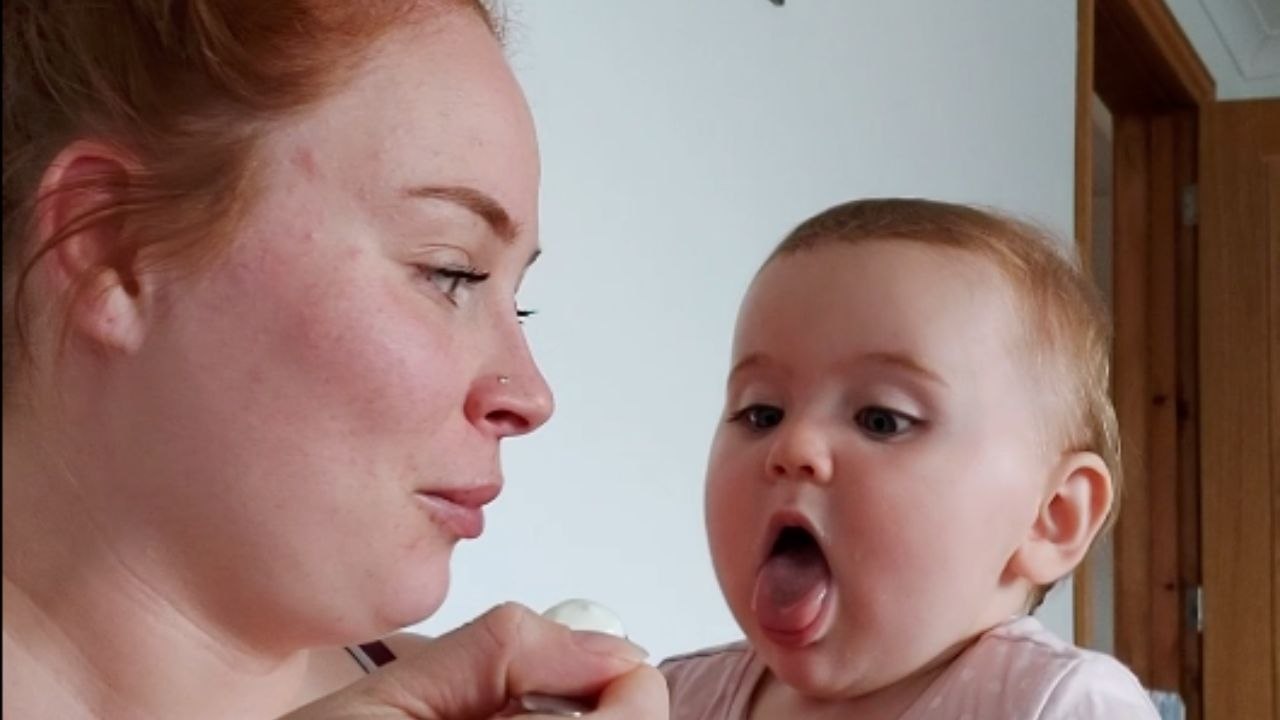 Mom teases baby daughter with her favorite food...