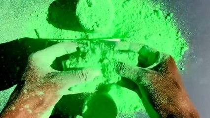 ASMR artist crushes dyed and dusty gym chalk with neon reforms
