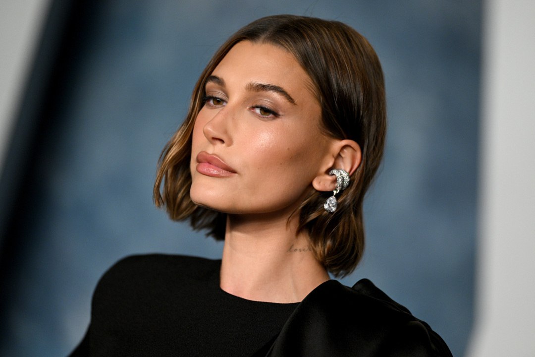 Hailey Bieber Paired the Tiniest Leopard String Bikini With a Turquoise Blue Bucket Hat