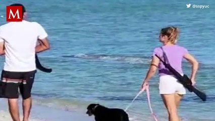 Turista se pasea por playas de Yucatán con un rifle