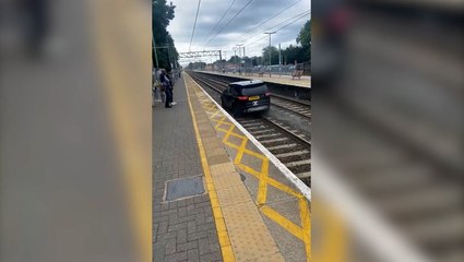 Moment man drives stolen Range Rover along train tracks to flee police