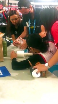 UE team captain Ja Lana being treated after spraining her right wrist in Set 2 versus Adamson