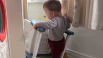 Little boy throws a tantrum when he cannot pass the chair through a door