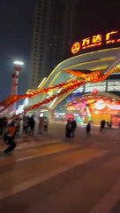 A kite shaped like phoenix controlled by a drone flies into the night sky   in Shangqiu, central China's Henan Province