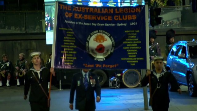 Australians gather at dawn services and marches to mark Anzac Day