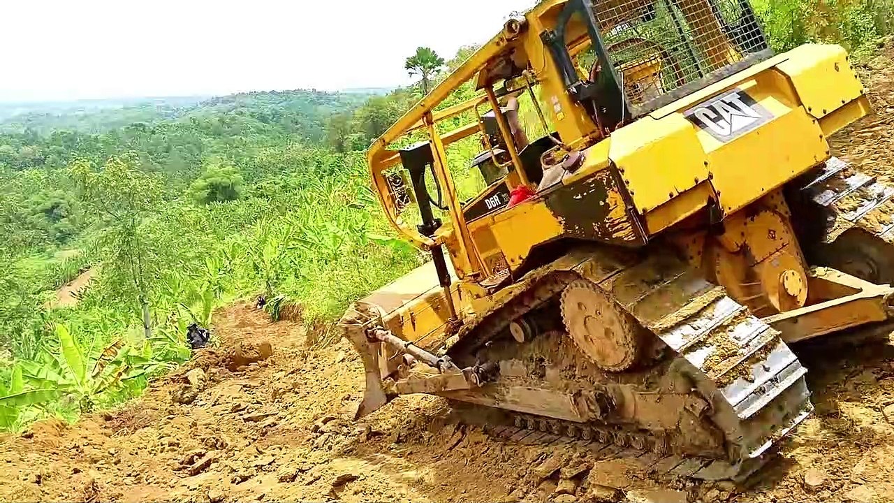 CAT D6R XL Bulldozer Cuts Steep Hill for Plantation Road Construction