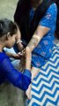 Woman applying henna on one hand to prepare for wedding ceremony, festival in India