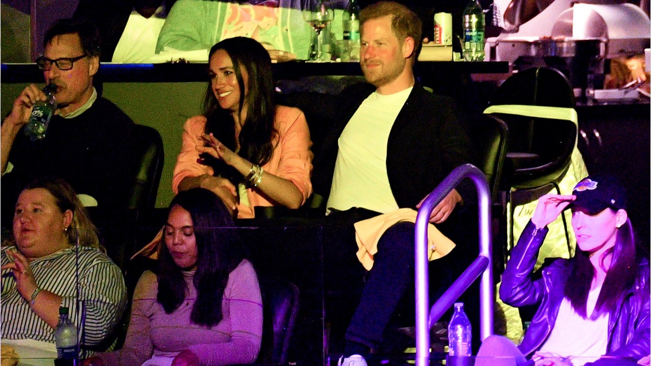 Prince Harry and Meghan Markle share a sweet 'kiss cam' moment at basketball game