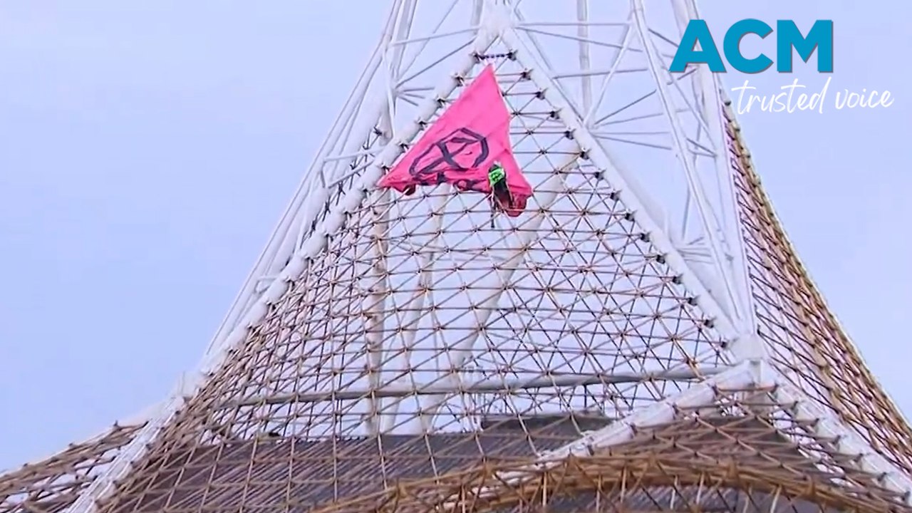 Extinction Rebellion activist scales Melbourne Arts Centre spire