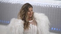 Gisele Bündchen Hits the 2023 Met Gala Red Carpet Solo in a Vintage Chanel Dress and Feather Cape