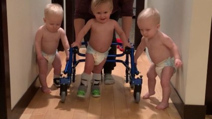 Tender-hearted boys stick by their triplet brother's side as he learns to walk using his posterior walker