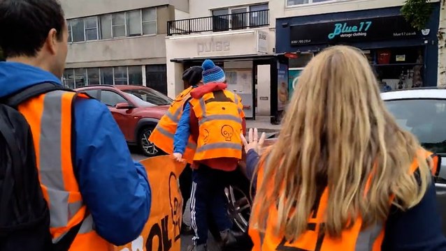 Moment motorist drives through Just Stop Oil protesters blocking road