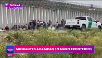 Migrantes acampan en el muro fronterizo; buscan solicitar asilo en EU