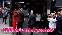 Prince William's arms protect Kate as they head to the Dog  Duck pub together