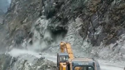 Moment boulders and debris rain down on road as cliff face collapses