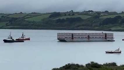 Watch: Three-storey barge expected to house migrants arrives at Falmouth