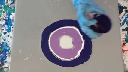 Artist reveals her amazing pouring technique to create perfect purple flower artwork