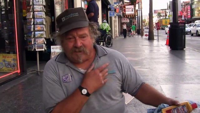 Has a one leg, John crawls on Hollywood's Walk of Fame to polish celebrity stars