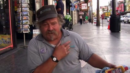 Has a one leg, John crawls on Hollywood's Walk of Fame to polish celebrity stars