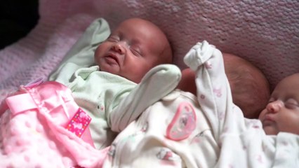 Married couple who beat one in 200 million odds by welcoming identical triplets have brought daughters home