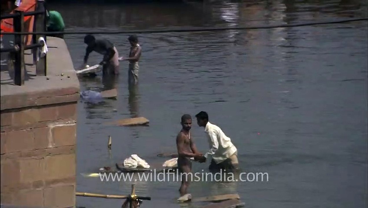 People wash clothes in the holy sacred water of Ganga, Varanasi
