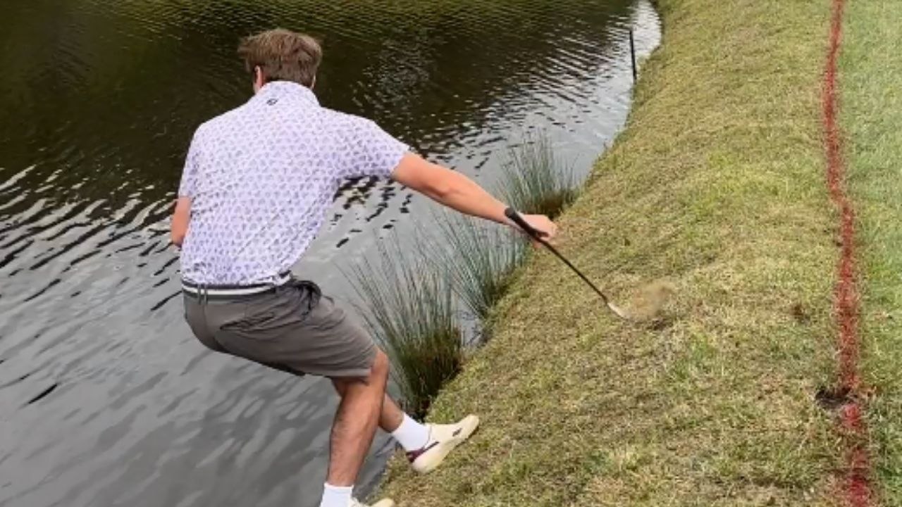 Man is forced to take a swim after his risky golf shot backfires big time!