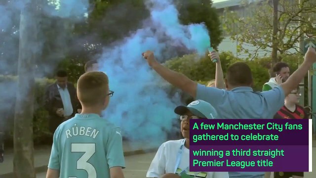 Manchester City fans celebrate winning the Premier League outside the Etihad