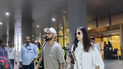 anushka sharma and virat kohli smile as they return to mumbai